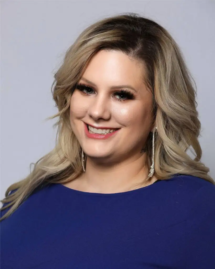 Professional Head shot of Malissa Veroni wearing blue sweater